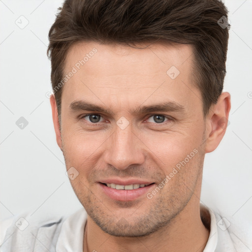 Joyful white young-adult male with short  brown hair and brown eyes