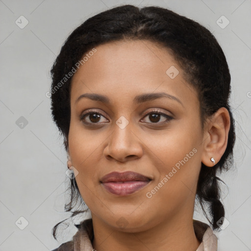 Joyful black young-adult female with long  black hair and brown eyes