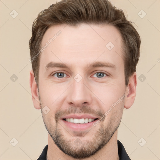 Joyful white young-adult male with short  brown hair and grey eyes