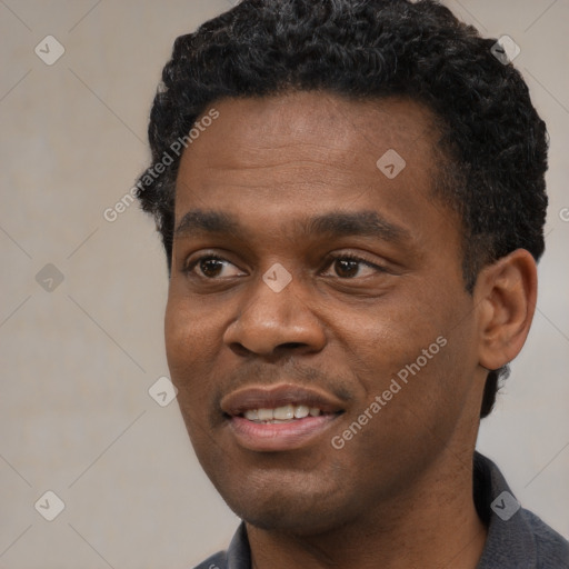 Joyful black young-adult male with short  black hair and brown eyes