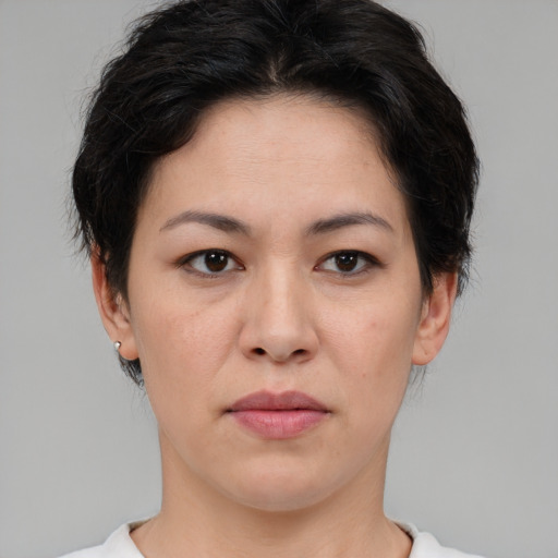 Joyful asian young-adult female with short  brown hair and brown eyes