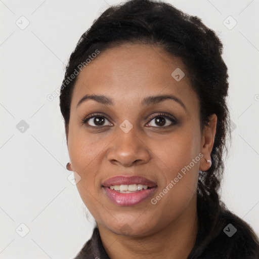 Joyful black young-adult female with long  black hair and brown eyes