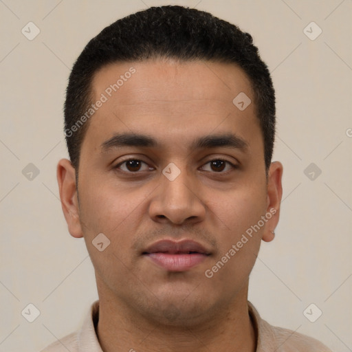 Joyful latino young-adult male with short  black hair and brown eyes