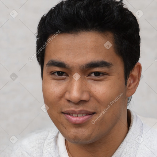 Joyful latino young-adult male with short  black hair and brown eyes