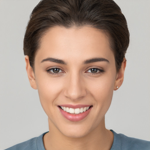 Joyful white young-adult female with short  brown hair and brown eyes