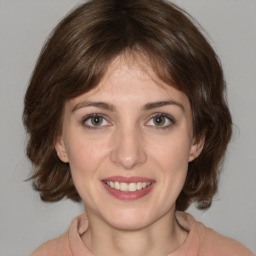 Joyful white young-adult female with medium  brown hair and green eyes