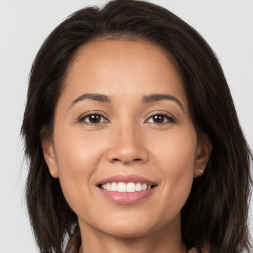 Joyful white young-adult female with long  brown hair and brown eyes