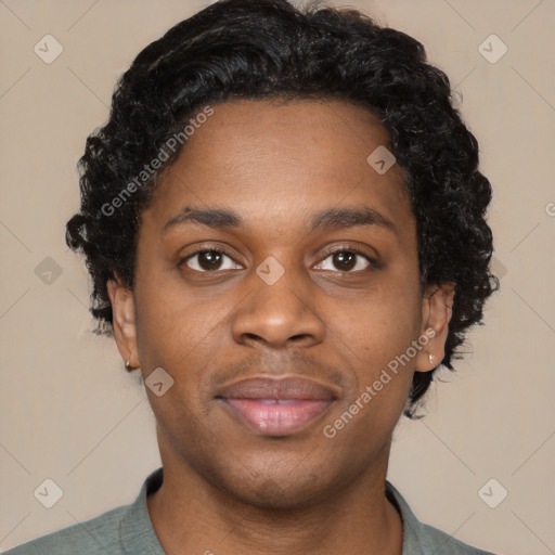 Joyful black young-adult male with short  black hair and brown eyes