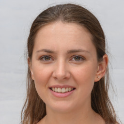 Joyful white young-adult female with long  brown hair and grey eyes