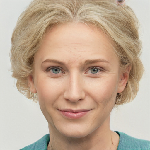 Joyful white adult female with medium  brown hair and blue eyes