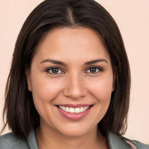 Joyful white young-adult female with medium  brown hair and brown eyes