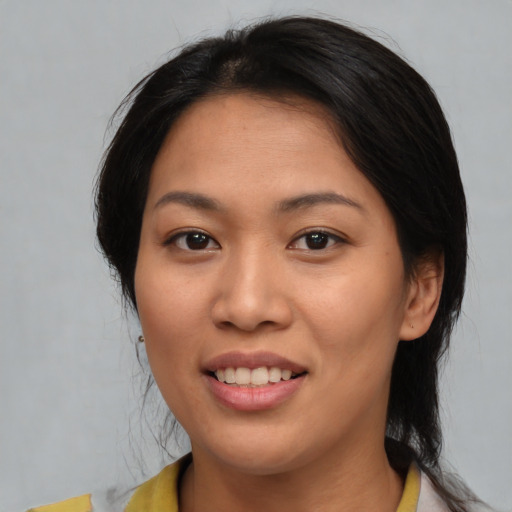 Joyful asian young-adult female with medium  brown hair and brown eyes