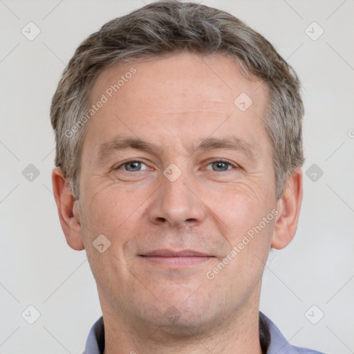 Joyful white adult male with short  brown hair and grey eyes