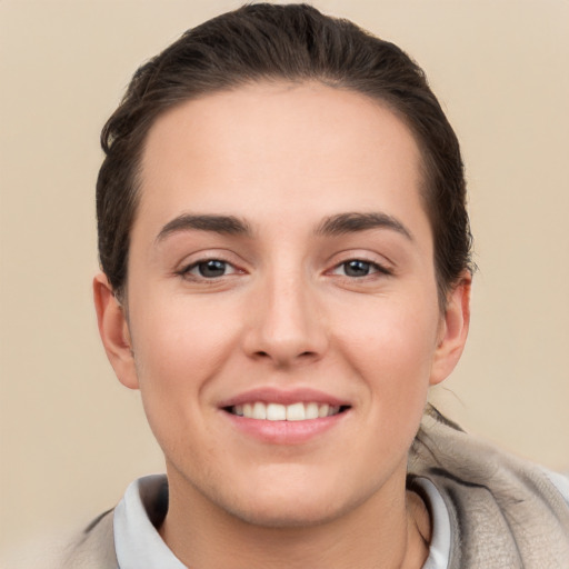 Joyful white young-adult female with short  brown hair and brown eyes