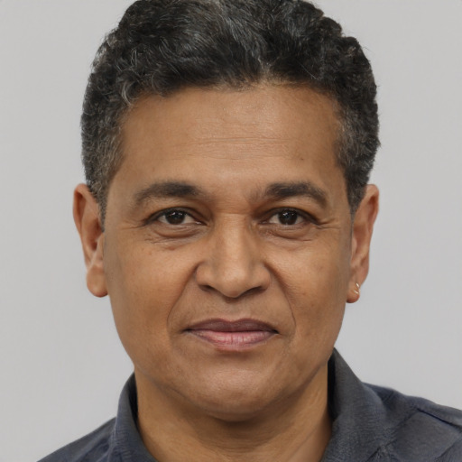 Joyful white adult male with short  black hair and brown eyes