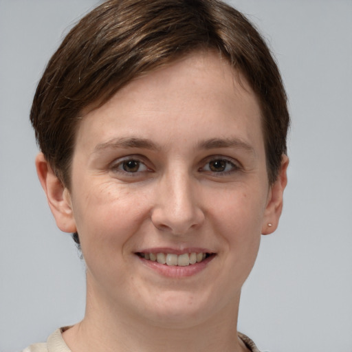 Joyful white young-adult female with short  brown hair and grey eyes