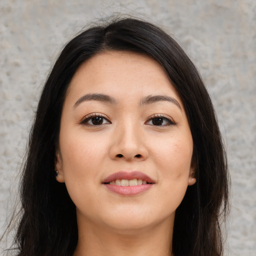 Joyful asian young-adult female with long  brown hair and brown eyes