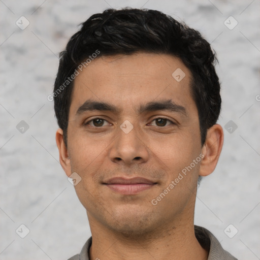 Joyful latino young-adult male with short  black hair and brown eyes