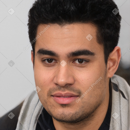 Joyful white young-adult male with short  black hair and brown eyes