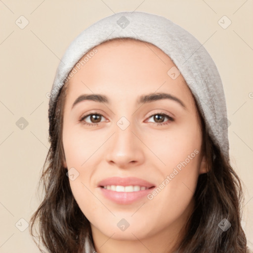 Joyful white young-adult female with long  black hair and brown eyes