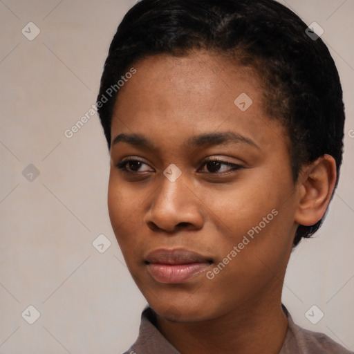 Joyful black young-adult female with short  black hair and brown eyes