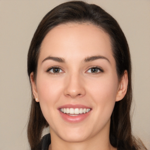 Joyful white young-adult female with long  brown hair and brown eyes