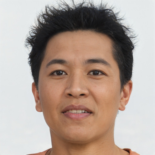 Joyful asian young-adult male with short  brown hair and brown eyes