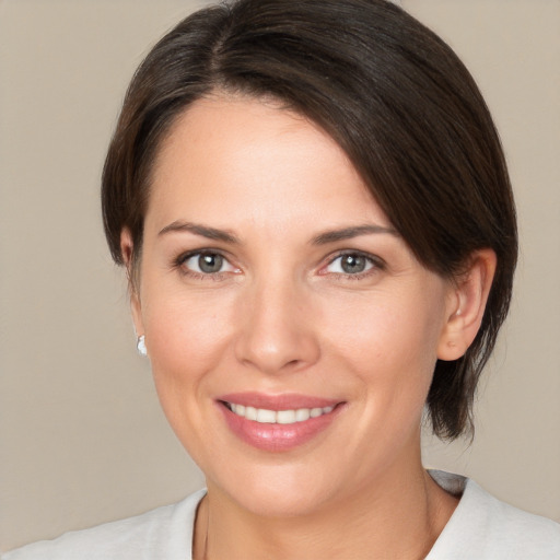 Joyful white young-adult female with medium  brown hair and brown eyes