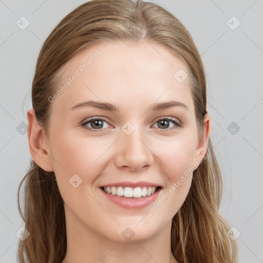 Joyful white young-adult female with long  brown hair and blue eyes