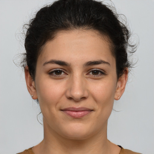 Joyful white young-adult female with medium  brown hair and brown eyes
