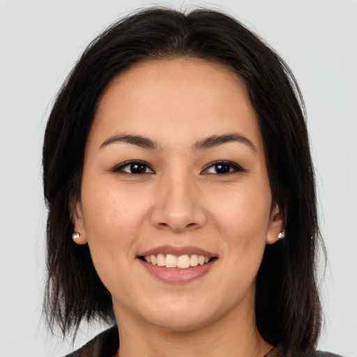 Joyful asian young-adult female with medium  brown hair and brown eyes