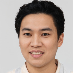 Joyful asian young-adult male with short  black hair and brown eyes