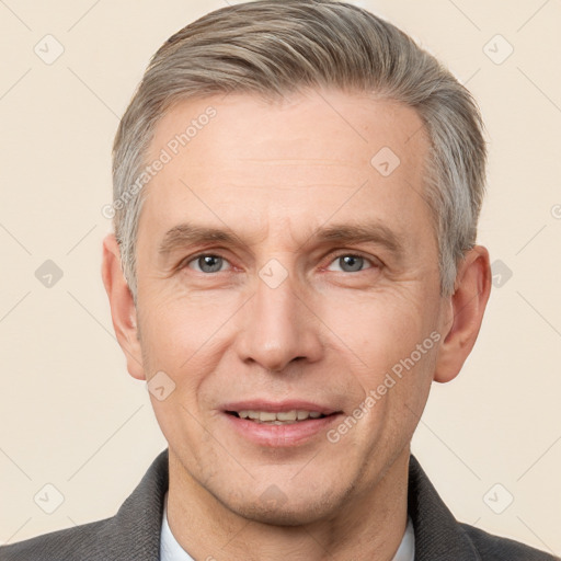 Joyful white adult male with short  brown hair and grey eyes