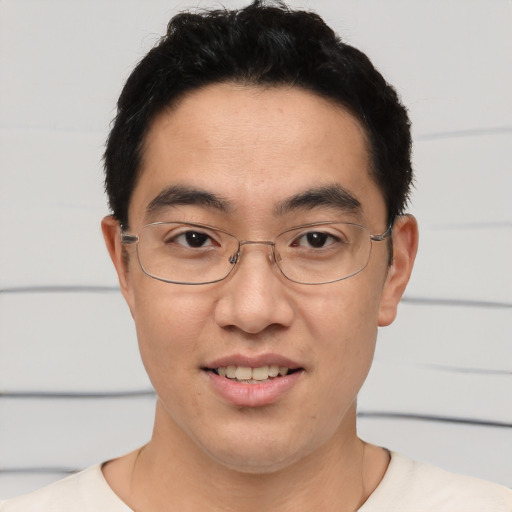 Joyful asian young-adult male with short  brown hair and brown eyes
