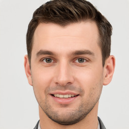 Joyful white young-adult male with short  brown hair and brown eyes