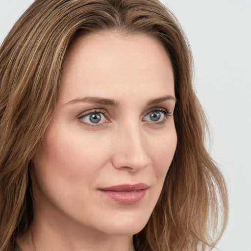 Joyful white young-adult female with long  brown hair and green eyes