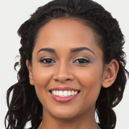 Joyful latino young-adult female with long  brown hair and brown eyes