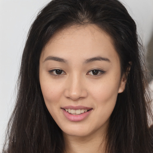 Joyful asian young-adult female with long  brown hair and brown eyes