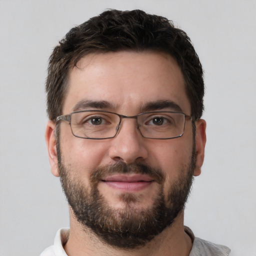 Joyful white adult male with short  brown hair and brown eyes