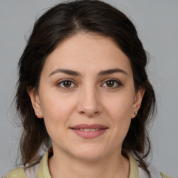 Joyful white young-adult female with medium  brown hair and brown eyes