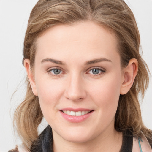 Joyful white young-adult female with medium  brown hair and blue eyes