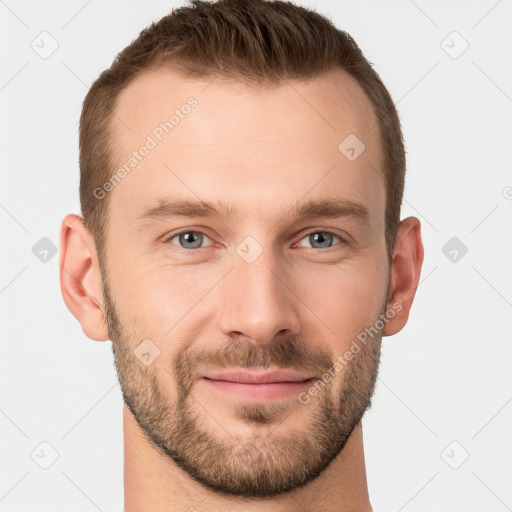 Joyful white young-adult male with short  brown hair and grey eyes