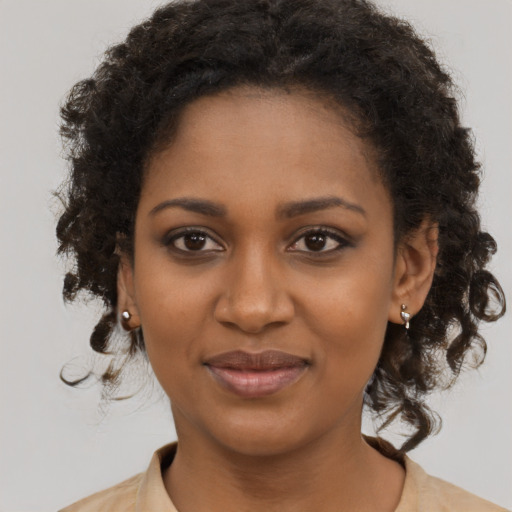 Joyful black young-adult female with medium  brown hair and brown eyes
