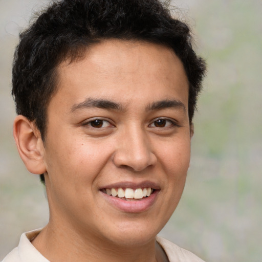 Joyful latino young-adult male with short  brown hair and brown eyes