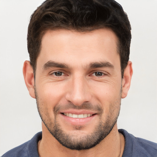 Joyful white young-adult male with short  brown hair and brown eyes