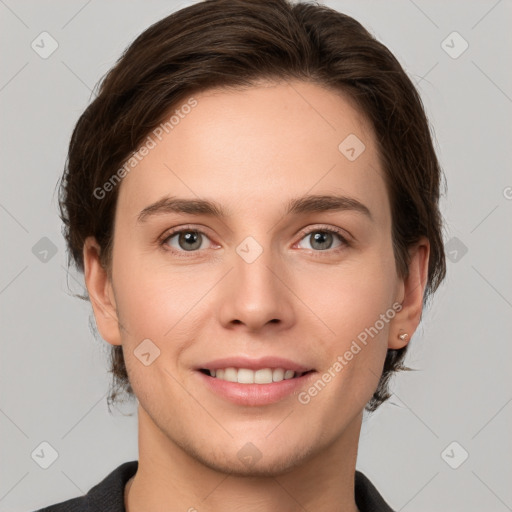 Joyful white young-adult female with short  brown hair and grey eyes