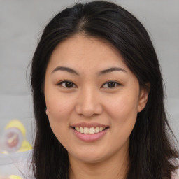 Joyful asian young-adult female with long  brown hair and brown eyes