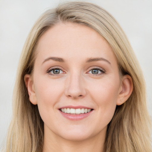 Joyful white young-adult female with long  brown hair and blue eyes