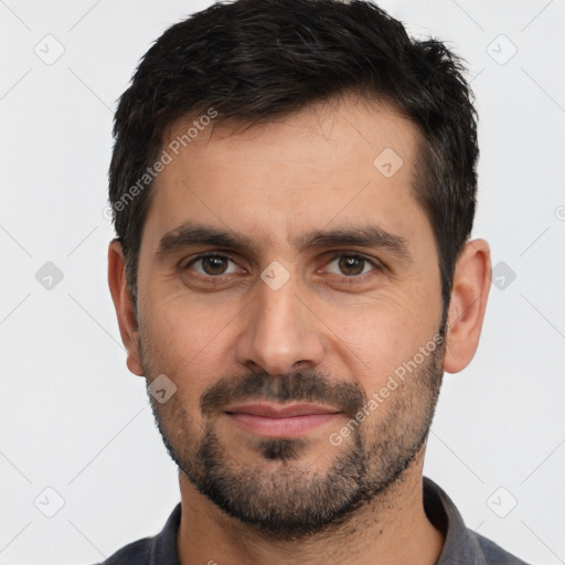 Joyful white young-adult male with short  black hair and brown eyes