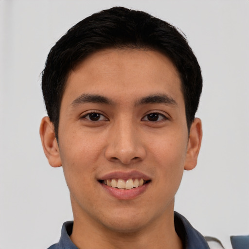 Joyful latino young-adult male with short  brown hair and brown eyes